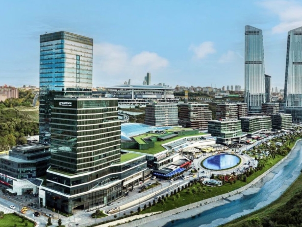 Aerial view of Vadistanbul, showcasing modern high-rise apartment buildings surrounded by lush greenery.